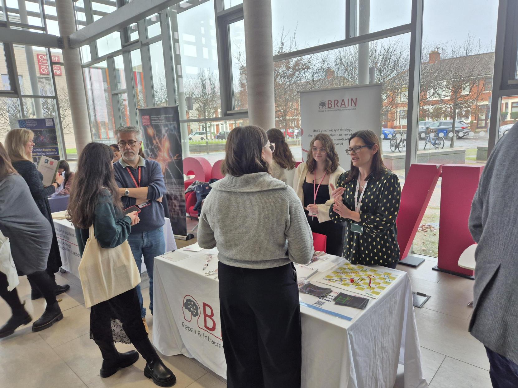 the advanced team at an event with members of staff speaking to the public.